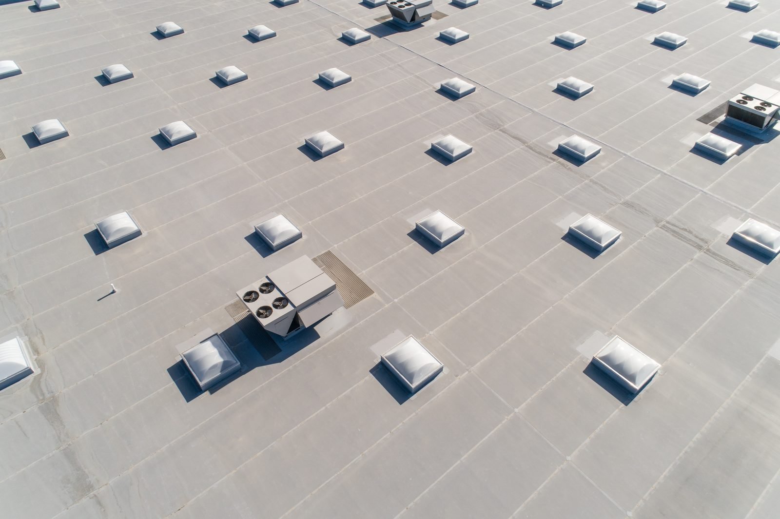 Aerial view of a flat commercial roof with skylights
