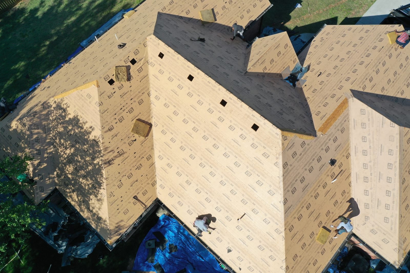 Aerial reroof in progress across complex gables