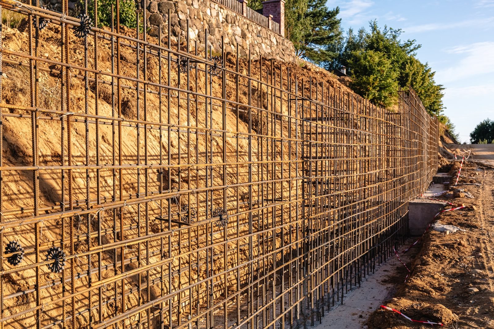 Engineered retaining wall rebar installation