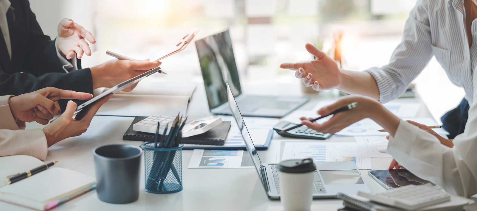 Engineering team reviewing a document around a conference table