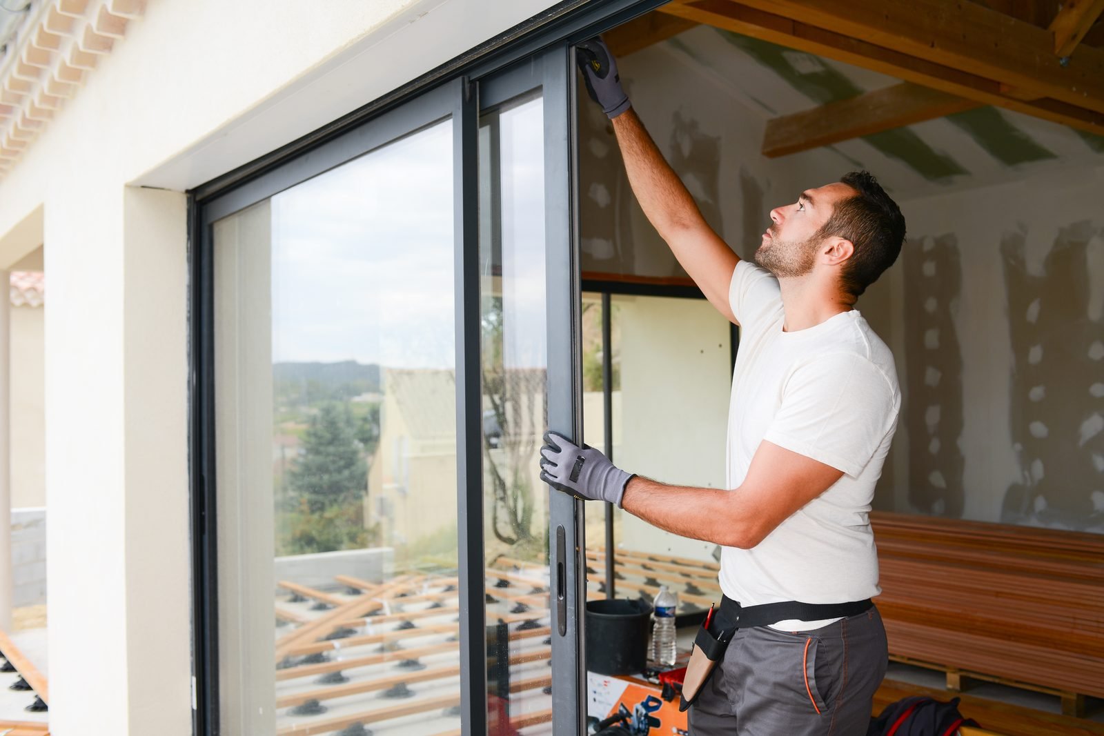 Installer aligning a sliding glass window panel